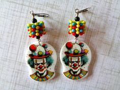 Colorful Creepy Clown Acrylic Charms accented with Blue, Red, Yellow and Green Plastic Daisy Spacers, Small Black Glass Beads and Silver Metal Beads.  Earrings measure 2.5". Boho Halloween, Creepy Clown, Beads Earrings, Acrylic Charms, Halloween Earrings, Metal Beads, Black Glass, Red Yellow, Jewelry Earrings Dangle