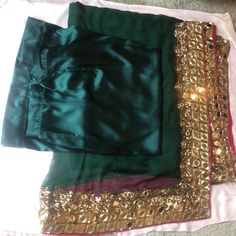 1.An Exclusively Custom Made Saree Set In Bottle Green French Pure Crinkled Chiffon With Gorgeous Silver Mirror Work With Gold Sequences Sprinkled Around It. Full Edge Border. 2. Hot Pink Stunning Raw Silk Blouse Embroidered Short Sleeves & Deep Back With String To Tie. 3. Bottle Green Silky Satin Inner Skirt To Wrap On Included For Complete Wear. No Matching Hassle. *Beautiful Eye Catching Wear For Weddings, Parties & Festivals. *Lightly Used For Around 2 Hours Only. Raw Silk Blouse, Green French, Embroidered Saree, Beautiful Eye, Silver Mirror, Embroidered Shorts, Bottle Green, Mirror Work, Silver Mirrors