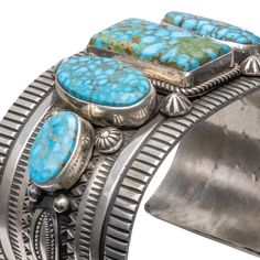 Size: 5 3/4 Width: 1 3/4" Gap: 1 1/2" Celebrate the rich heritage of Navajo craftsmanship with this exquisite cuff featuring Birdseye Kingman Turquoise. Masterfully created by Albert Jake, this cuff features hand-stamped designs meticulously crafted with precision and care. Star buttons add a celestial touch, while the arrangement of five turquoise stones creates a harmonious balance of color and form. Each stone is a testament to the natural beauty and intricate patterns found in the heart of the desert. With Jake's expert craftsmanship and attention to detail, this cuff presents a refined and elegant addition to any collection, perfect for those who cherish the beauty of traditional jewelry-making techniques. Wrangler Accessories, American Indian Jewelry, Star Buttons, Turquoise Cuff, Turquoise Stones, Kingman Turquoise, Traditional Jewelry, Pendant Rings, Cuff Earrings