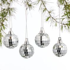 three disco ball ornaments hanging from a tree