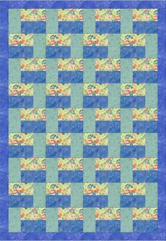 a blue and green quilt with flowers on it