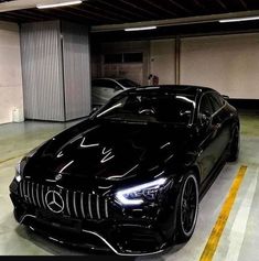 a black sports car parked in a parking garage