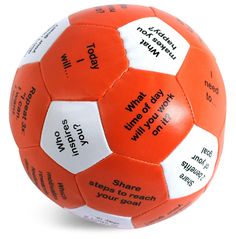 an orange and white soccer ball with words on it