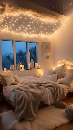 a bedroom with lights on the ceiling and bed in front of a window that has a fluffy white blanket draped over it