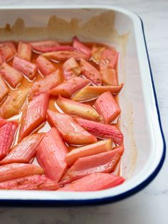 sliced rhubarb in a baking dish ready to be cooked and put into the oven