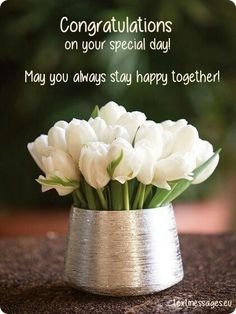 a vase filled with white flowers on top of a table