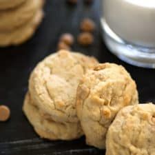 cookies and milk sitting on a table next to each other