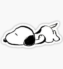 a black and white sticker of a dog laying on its back with it's eyes closed