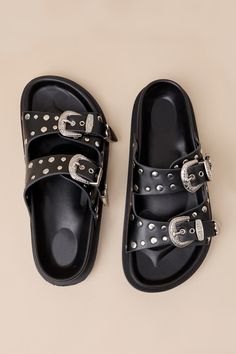 The Devaney Black Studded Western Buckle Slide Sandals were made for effortless styling, so you can spend more time out in the sun having fun! These faux leather sandals feature an almond-shaped footbed and wide adjustable straps embellished with silver studded details and Western-inspired buckles and tips with intricate embossing. A contoured insole completes the simple slide-on design. 0. 75" rubber sole. Smooth insole. Rubber sole has nonskid markings. Man made materials. Imported. Lulus | De Trendy Adjustable Strap Sandals, Adjustable Open Toe Flip Flops With Buckle Closure, Summer Flat Heel Flip Flops With Buckle Closure, Adjustable Buckle Closure Open Toe Flip Flops, Adjustable Buckle Closure Summer Sandals, Trendy Summer Footbed Sandals With Round Toe, Adjustable Buckle Closure Footbed Sandals For Vacation, Trendy Strap Sandals For Vacation, Trendy Summer Flip Flops With Buckle Closure