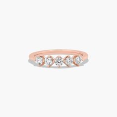 a rose gold ring with three diamonds