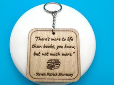 there's more to life than books, you know, but not much words keychain