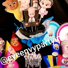 a table topped with cake toppers and cupcakes