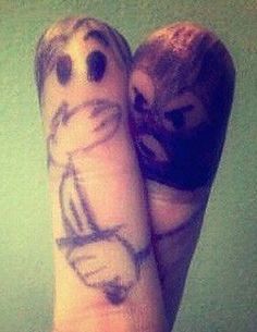 two feet with faces drawn on them and one is holding a doughnut in the other hand