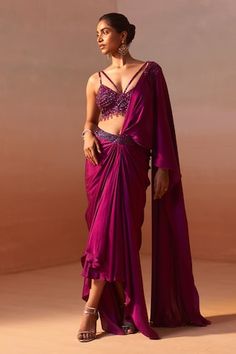 Purple pre-draped asymmetric satin saree with tonal sequin embellishments on the waistband and shoulder. Paired with a strappy bustier with sequin, cutdana and bead embroidery. - Aza Fashions Glamorous Draped Embellished Choli, Hand Embellished Fitted Silk Pre-draped Saree, Embellished Fitted Draped Choli, Pre-draped Embellished Fitted Saree, Embellished Fitted Pre-draped Saree, Embellished Fitted Draped Saree, Embellished Pre-draped Saree For Reception, Embellished Pre-draped Saree, Embellished Pre-draped Silk Saree