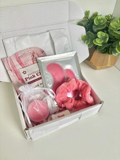 a pink gift box containing soaps and other items