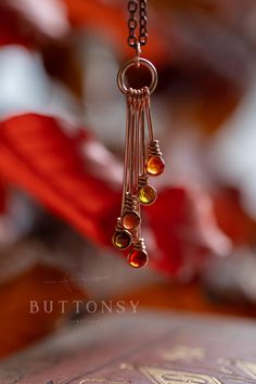 This is a gorgeous copper necklace, in stunning Autumn colours, made to match our copper Autumn earrings (last photo), which are here: https://www.etsy.com/uk/listing/1769103599/ We have handmade tiny drop bezels out of real copper, and filled each with beautiful Autumn-coloured resin... a cluster of them is hanging from a copper jump ring, and they hang from a copper chain. They look like a constellation of falling stars, and have a wonderful drop of 5cm, or 2 inches. Each necklace is an absolute one of a kind - there will never be the same configuration twice, so you will be wearing a one of a kind necklace: yours won't be the one in the photo but it will be just as Autumny and magical. Different shades and configuration of colours... just as Autumn-y. This is gorgeous statement jeweller Copper Autumn, Thanksgiving Jewelry, Autumn Earrings, Boho Soul, Copper Jewellery, Autumn Necklace, Falling Stars, Autumn Colours, Fall Earrings