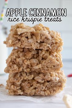 three apple cinnamon rice krispy treats stacked on top of each other in front of a glass of milk