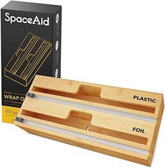 a pair of scissors in a wooden box next to a cardboard box with the words space aid on it