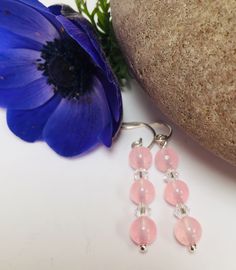 These elegant earrings are made from sterling silver with pretty pastel pink rose quarz gemstones and Swarovski crystals. They have handcrafted sterling silver fittings. The perfect gift for any occasion. Rose Quartz brings the energy rays of determination, commitment, and caring. Its soothing colour calms feelings of anger or resentment, and can aid efforts to meditate and reflect. Pink is the colour of new love, new romance and new relationships. Earring Drop - 4 cm (1.5 inches) All measurements are approximate. All items are wrapped in tissue paper, inside an organza bag and posted in a padded envelope. Pink Crystal Round Earrings For Gift, Pink Sterling Silver Earrings For Pierced Ears, Elegant Nickel-free Rose Quartz Earrings, Pink Round Sterling Silver Earrings, Pink Sterling Silver Round Earrings, Pink Sterling Silver Crystal Earrings As Gift, Pink Rose Quartz Earrings Gift, Handmade Pink Crystal Earrings In Sterling Silver, Pink Crystal Ear Wire Earrings For Gift