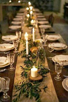 a long table is set with candles and place settings for the dinner guests to enjoy