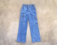 --  Vintage 1970s K Mart Cargo Pocket Light Blue Flare / Wide Leg Jeans --  Very good condition with general light wear, but look very nice overall!  --  Super cool design and ideal for designers and purveyors of good style --  Size 27 x 31 1/2, but please see below for measurements --  Thanks for looking and have a fantastic day! MEASUREMENTS Waist - 13 1/2 inches across; 27 inch waist Hips - 17 1/2 inches across; 35 inch hips Rise - 11 1/8 inches Inseam - 31 1/2 inches Total Length - 42 inches Vintage Denim Blue Cargo Jeans For Spring, Vintage Cargo Jeans In Denim Blue For Spring, Vintage Straight Leg Cargo Jeans For Spring, Vintage Wide Leg Denim Blue Cargo Jeans, Vintage High Rise Cargo Jeans For Spring, Vintage Blue Wide Leg Cargo Jeans, Vintage Blue Cargo Jeans With Pockets, Vintage Medium Wash Cargo Jeans For Spring, Vintage Blue Cargo Jeans