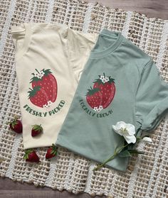 Are you attending the strawberry festival this year or just love this sweet little fruit? This stylish tshirt is perfect for you! Dress it up with a skirt or down with jeans! The t-shirt itself is super soft and a comfy fit! The design is a dtf transfer and will last through all the washes! T-shirts are Bella Canvas brand and are a unisex fit. Women's fit tees are available upon request! All shirts are made to order and my current turn around time is about 2 weeks until your order will ship. Please keep this in mind when ordering. Organic Short Sleeve T-shirt For Spring, Fitted Summer T-shirt With Strawberry Print, Fitted Strawberry Print T-shirt For Summer, Sweet Cotton Tops With Fruit Print, Sweet Red Summer Tops, Sweet Strawberry Print Short Sleeve T-shirt, Cute Strawberry Print Tops For Spring, Sweet Style T-shirt With Funny Print For Spring, White T-shirt With Fruit Design For Spring