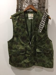 "A great piece of history that never went out of fashion in the woods or in a coffee shop. 1950s Foremost by J.C. Pennys hunting camo vest. Fabric: lightweight 35% Cotton 65% Polyester. Size: men's medium Condition: very good, clean, zipper and buttons  work well. Measurement: Lying flat Shoulder to shoulder: 16.5\" Bottom opening: 21\" Length: 24\" Underarm to underarm: 21\" If you have any question feel free to contact me. My reviews are 5 star." Camo Vest, Hunting Vest, Hunting Camo, Vest Outfits, 1950s Vintage, Western Outfits, In The Woods, Vest Dress, 5 Star