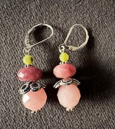 Introducing stunning sterling silver earrings adorned with lively Fun Candy Jade stones in shades of pink, red, and lime. These earrings boast a modern design with a smooth flat lever back and a stylish 1-inch drop length. Vibrant Handmade Dangle Jewelry, Multicolor Gemstone Drop Earrings, Multicolor Vibrant Jewelry With Ear Wire, Vibrant Dangle Earrings With Ear Wire, Pink Gemstone Dangle Jewelry, Pink Gemstone Jewelry For Jewelry Making, Fusion Style Earrings With Natural Stones, Unique Multicolor Gemstone Earrings, Vibrant Multicolor Jewelry With Ear Wire