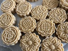 some very pretty looking cookies on a plate with flowers in the middle and circles around them