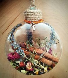 a glass ornament filled with dried flowers and herbs