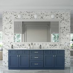 a bathroom vanity with blue cabinets and white tiles on the wall, along with a large mirror above it