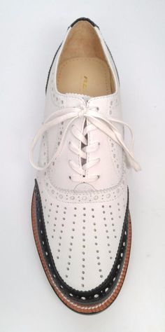 Our sporty 1930's golf oxford. Featuring walled toe styling and hand-perforated patterns.  All leather construction with leather soles Men's whole and half sizes, 5-13 Standard "D" width Imported Textured Sole Wingtip Oxfords, Leather Oxfords With Perforated Almond Toe, Spring Wingtip Oxfords With Textured Sole, Leather Oxfords With Perforated Toe Box And Almond Toe, White Lace-up Oxford Shoes, Spring Wingtip Oxfords With Leather Sole, Spring Wingtip Leather Shoes With Textured Sole, Formal Oxford Shoes With Perforations, Low-top Oxfords With Brogue Detailing