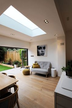 a living room filled with furniture and a skylight