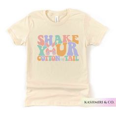 "Kids will love this \"SHAKE YOUR COTTON TAIL\" youth short sleeve tee. This lightweight side-seamed shirt maximizes comfort all day long.  Shake Your Cotton Tail Kids Shirt, Funny Easter Bunny Youth T-Shirt, Groovy Easter Bunny Retro, Christian Shirt Rabbit Tee Bunny Kids Gift 🌟100% Airlume combed and ringspun cotton (fiber content may vary for different colors) 🌟Light fabric (4.2 oz/yd² (142 g/m 🌟Retail fit RETURNS: All products are made-to-order and because of the nature of these items, all sales are final unless they arrive damaged or defective. CARE INSTRUCTIONS Machine wash: cold (max 30C or 90F); Non-chlorine: bleach as needed; Tumble dry: low heat; Iron, steam or dry: medium heat; Do not dryclean. PLEASE SEE THE SIZING CHARTS for the measurements, and please consider comparing t Spring Screen Print Stretch T-shirt, Spring Stretch T-shirt With Screen Print, Cute Stretch T-shirt For Spring, Spring Text Print Stretch T-shirt, Spring Stretch T-shirt With Text Print, Stretch Short Sleeve Shirt With Letter Print, Crew Neck Shirt With Graphic Print And Stretch, Cute Stretch Cotton T-shirt, Short Sleeve Stretch T-shirt With Text Print