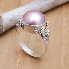 Crowned by an orb of cultured pearl with soft, dyed pink hues, this Balinese cocktail ring brings a sweet beauty wherever it goes. Designed by Buana, the band is handcrafted of sterling silver with jepun, or frangipani flowers that flank the pearl. Mabe Pearl Jewelry, Pink Frangipani, Pearl Cocktail Ring, Goddess Jewelry, Mabe Pearl, Balinese, Pearl Color, Favorite Rings, Jewelry Packaging