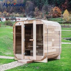 a wooden sauna is sitting in the grass