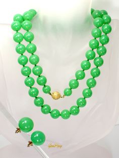 "This is an original Art Deco 1930s vintage green faux Jade Celuloid / Early Plastic  jewelry set: beaded necklace and clip-on earrings. The necklace measures almost 29\" long, it weighs 1.4 oz and the beads are 3/8\" in diameter.  The earrings are 3/4 in diameter and the weight of one earring is 0.1 oz.  It is a vintage item in excellent condition. We combine shipping,  Thank You for visiting our Etsy https://www.etsy.com/shop/VictoryIssweet store!" Green Single Strand Jewelry For Party, Single Strand Green Jewelry For Party, Vintage Jade Beaded Necklaces, Classic Green Beaded Necklaces With Round Beads, Formal Green Single Strand Beaded Necklace, Formal Green Beaded Necklace, Vintage Jade Necklace For Formal Occasions, Vintage Green Single Strand Necklace, Vintage Green Clip-on Jewelry