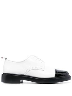 two-tone leather brogues from THOM BROWNE featuring white/black, calf leather, patent leather, almond toe, front lace-up fastening, perforated detailing, branded insole, tricolour pull tab and low stacked heel. Leather Brogues, Derby Shoes, Thom Browne, Stacked Heel, Flat Shoes Women, Calf Leather, Derby, Patent Leather, Rubber Sole