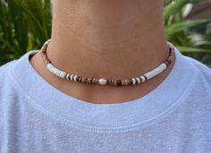 Our Canggu Necklace is one of our bestsellers! Featuring natural shells and pearl, this style is sure to be stand out on your summer adventure. Wear this on your casual day or dress it up for a signature beachy feel.  Freshwater pearl Puka Shells  Coconut Shell Wood Wax Cord approx 16" with adjustable 7" knot - adjustable and waterproof! Matching bracelet and anklet!   Mix and match with your favorite HALT pieces or wear alone for boho beach vibes. The perfect gift for him or her. Our jewelry is handmade in the Sunshine State with local materials and shipped with an effort to use environmentally friendly packaging, making it the perfect choice for those who shop with a green mindset. Puka Shell Necklace Outfit, Beachy Bracelets, Vacation Accessories, Wood Wax, Puka Shell, Matching Bracelet, Perfect Gift For Him, Sunshine State, Coconut Shell