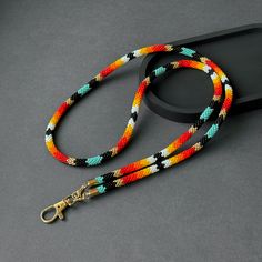 Elevate your accessory game with our Ethnic Style Lanyard, perfect for teachers and professionals seeking both style and versatility. This Native Inspired Seed Bead Lanyard is not only a visually stunning ID card necklace but also a functional holder for keys, making it ideal for everyday use. Crafted with vibrant, intricate beadwork, its unique design captures the essence of ethnic artistry. The real highlight of this lanyard is its adaptability. Included in the package are special loops that a Bohemian Multicolor Beaded Necklaces For Everyday Use, Bohemian Multicolor Beaded Necklaces, Bohemian Multicolor Beaded Necklace For Everyday, Multicolor Beaded Necklaces With Round Beads For Everyday, Multicolor Round Beaded Necklaces For Everyday, Seed Bead Lanyard, Teacher Badge Holder, Bead Lanyard, Card Necklace