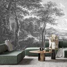 a living room with a large mural on the wall and green couches in front of it