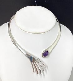 "Vintage Sterling Silver & Amethyst Clamper Necklace - Very unique asymmetric modern design - Hinged clamper closure - One large bezel set amethyst cabochon - Hallmarked \"Mexico 925\" and other letters which are difficult to make out \"DMF\" or \"OMP\" - The necklace measures about 16.5\" end to end - Amethyst stone measures about 14mm x 10mm oval - Total weight 79g - In very nice condition, silver appears newly polished, light surface scratches to the silver consistent with typical wear. A lov Luxury Sterling Silver Cabochon Necklaces, Modern Amethyst Jewelry, Modern Purple Amethyst Jewelry, Modern Purple Metal Jewelry, Modern Adjustable Purple Jewelry, Architectural Jewelry, Three Necklaces, Bib Necklaces, Funky Jewelry