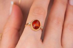 Our amber ring is 14k solid rose gold. It has an oval-cut genuine amber crystal between round zircon stones. Our gold amber ring will accompany you all day long. When you consider it as a gift, it will be a perfect gift choice for your loved ones. Our dainty birthstone ring makes happy your loved ones on their birthdays, graduations, mother's day, anniversaries, or valentine's day. Especially, it is an excellent gift for your loved ones who is sign Leo. Altogether, our gold amber ring is even us Gold Amber Ring, Amber Crystal Ring, Amber Ring Engagement, Amber Ring Gold, Amber Engagement Ring, Amber Rings, Fire Jewelry, Leo Birthday, Raw Stone Ring