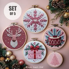 four embroidered christmas ornaments on a pink background with the text set of 5 written below