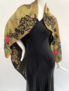 "This vibrant antique 1920s to 1930s lamé shawl or scarf is made from metallic threads in a gold colour with stylised floral details in shades of pink, blue, yellow, green and black. This can be worn on both sides (you can see it worn each way in the photos). This is a versatile piece that can be worn folded or unfolded in a variety of different ways.  It is a smaller size, measuring approximately 40\" inches by 38\" inches, please check that the size will meet your needs before you purchase.  The condition is good overall with some areas of darkening to the gold metallic threads in places, this is to be expected with a shawl of this age. This is most noticeable in a section on the gold side of the shawl (it is visible on the black side but less so), and along the fold lines on the gold si Cape Fashion, Pink Blue Yellow, Vintage Gowns, Vintage Mode, Shawl Scarf, Black Side, Gold Colour, Shades Of Pink, Green And Black