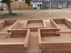 a group of wooden boxes sitting in the middle of a yard