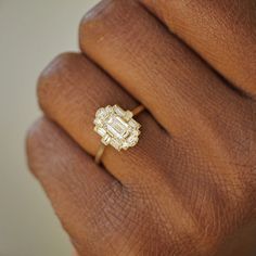 a woman's hand with a diamond ring on it