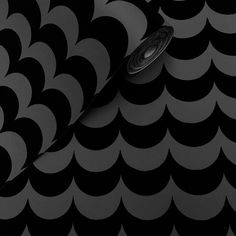 an abstract black and white wallpaper with circular shapes in the center, as well as a round object on top