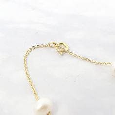 Our Freshwater Pearl Double Chain Wedding Bracelet, crafted with 18ct gold-plated copper and adorned with freshwater pearls, is the perfect elegant gift for brides, bridesmaids, or any special occasion.  Elevate your bridal ensemble with our Freshwater Pearl Double Chain Wedding Bracelet, an exquisite accessory perfect for bridesmaids or brides on their special day.   This jewellery arrives beautifully packaged and ready to gift. It would make a really thoughtful and meaningful birthday gift, Ch Delicate Gold Chain Bracelet With Pearls, Classic Gold Bracelets With Pearl Charm, Classic Gold Bracelet With Pearl Drop, Dainty Gold Pearl Bracelet With Pearl Charm, Elegant Single Strand Baroque Pearl Bracelets, Luxury Gold Akoya Pearl Bracelet, Luxury Gold Pearl Necklace For Wedding, Wedding Baroque Pearl Chain Bracelet, Refined Gold Wedding Jewelry