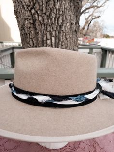 Ready to add a little twist to your brim? The band is 22.5" x 1.5" and has adjustable ties in the back so it can fit hats from 22.5-34". The bottom layer is soft black suede that will look good on all hats. The top layer has is silk ribbons that have been braided to complement the leather and really bring the colors to life. The blue, white, silver and black will compliment your hat. As with all of our custom-made pieces each piece is unique and little different each time made. Please let us kno Adjustable Brimmed Felt Hat For Country Events, Country Style Hat With Adjustable Curved Brim, Country Style Adjustable Hat With Curved Brim, Adjustable Brimmed Country Felt Hat, Adjustable Brimmed Country Style Felt Hat, Adjustable Wide Brim Felt Hat For Country Events, Adjustable Wide Brim Felt Hat For Rodeo, Adjustable Felt Hat For Summer Country Events, Adjustable Hat Bands For Country Events In Fall